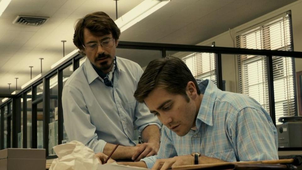 two men try to crack the zodiac cipher in a scene from zodiac, a good housekeeping pick for best halloween movies