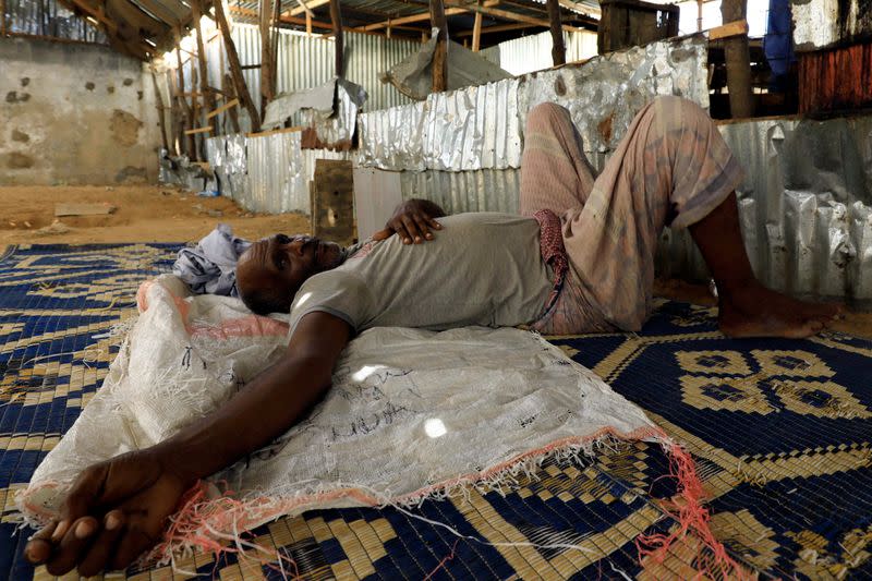 Bunow Hussein Aden, 60, a Somali market cleaner is seen at the abandoned khat stimulant market closed amid concerns about the spread of coronavirus disease (COVID-19), during a Reuters interview in Mogadishu