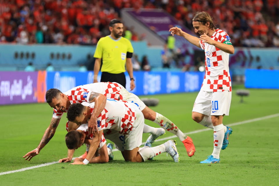 DOHA, QATAR - NOVEMBER 27: Andrej Kramaric #9 of Croatia celebrates with teammates after scoring a goal during the Qatar 2022 World Cup Group F football match between Croatia and Canada at the Khalifa International Stadium in Doha on November 27, 2022. (Photo by Serhat Cagdas/Anadolu Agency via Getty Images)