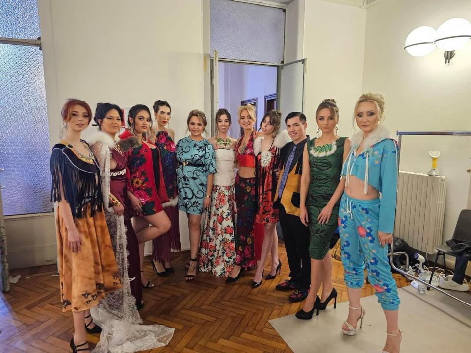 Yukon designer Natasha Peter, in the centre wearing a blue and black dress, with some models wearing her Kaska Dena Designs creations, at Milan Fashion Week. (Submitted by Natasha Peter - image credit)