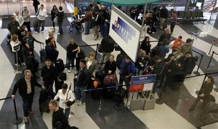 Passengers wait in line at the Spirit Airlines ticket counter at the O'Hare International Airport in Chicago