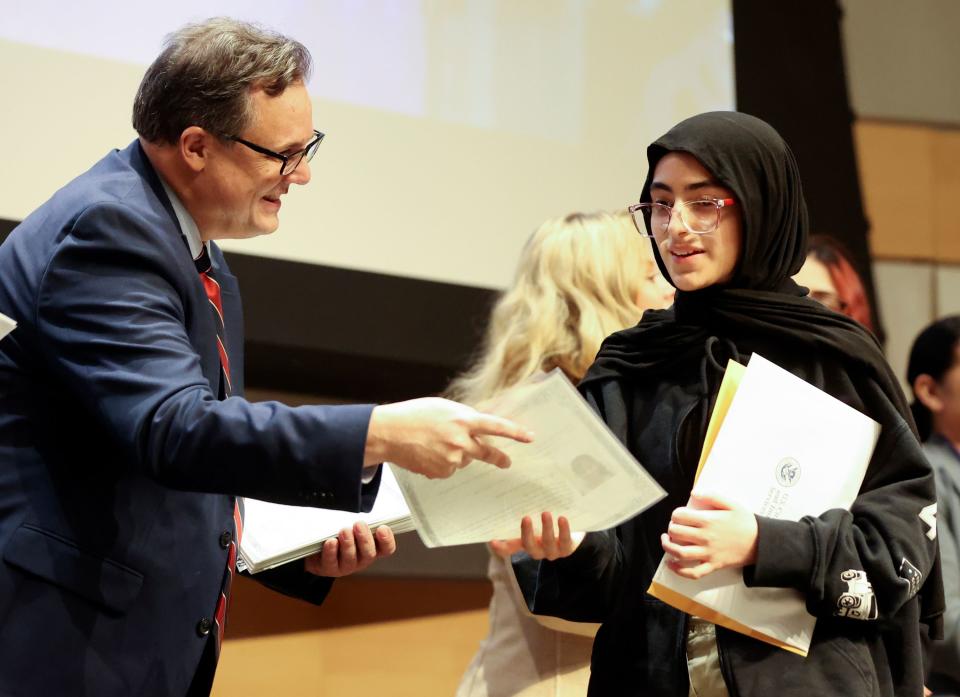 Jumana Raheem receives her certificate of citizenship during a naturalization ceremony at the Salt Lake City Public Library in Salt Lake City on Wednesday, Feb. 14, 2024. | Kristin Murphy, Deseret News