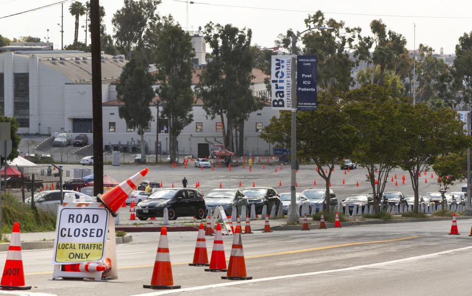 Long lines await people who were scheduled to be tested for COVID-19 at a drive-up testing site in Elysian Park, Los Angelas Thursday, April 2, 2020. Officials say hand-washing and keeping a safe social distance are priorities in battling the COVID-19 virus. (AP Photo/Damian Dovarganes)