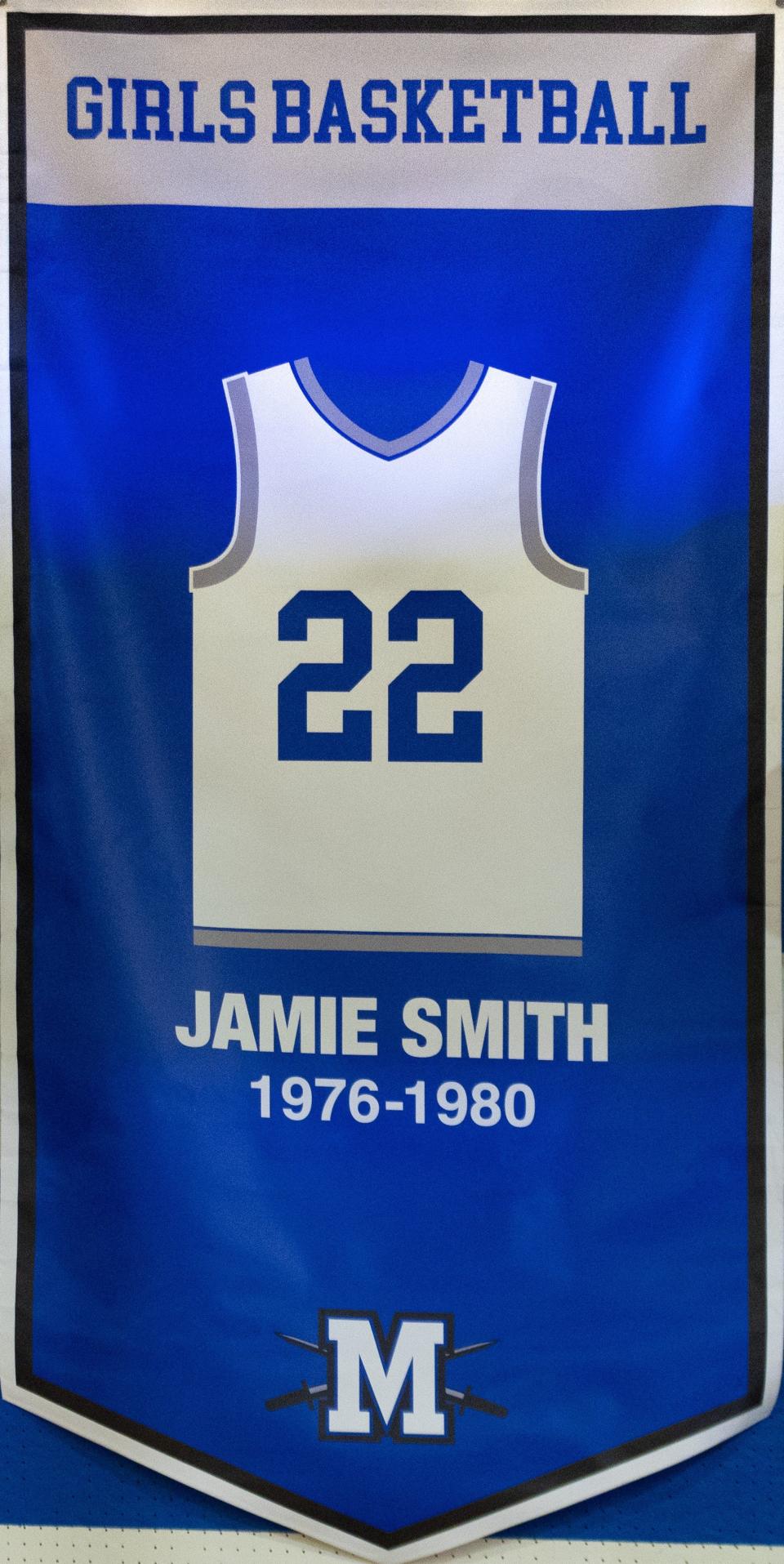 The banner honoring McCallum High School's retiring of Jamie Smith's basketball jersey was unveiled in a Dec. 20 ceremony.