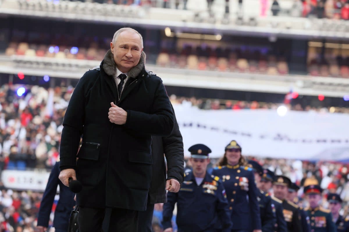 Vladimir Putin attends a concert for Russian service members in Moscow on Wednesday. (via REUTERS)