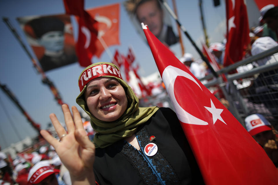 A Turkish woman waves to camera