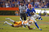 Florida quarterback Emory Jones (5) tries to get past Tennessee defensive back Jaylen McCollough, left, during the second half of an NCAA college football game, Saturday, Sept. 25, 2021, in Gainesville, Fla. (AP Photo/John Raoux)