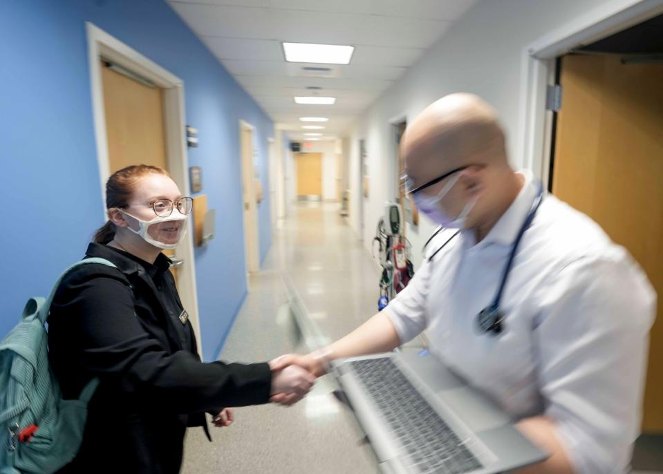 Hannah Moral, a University of Wisconsin-Milwaukee American Sign Language Studies School of Education student, shakes Dr. Jackson Nguyen's hand prior to her interpreting for a volunteer deaf patient, Melanie Kaplan, not pictured, Friday, Feb. 24, 2023, at Ascension Columbia St., Mary's Milwaukee - Prospect Medical Commons located at 2311 N. Prospect Ave., Milwaukee. This experience gives students the opportunity to have real-world experience with translating in a medical setting. UWM has a four year program for interpreting.