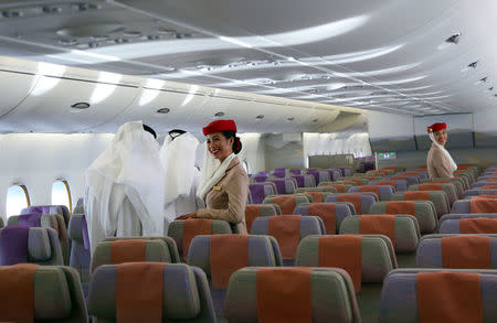 Fligt attendants look on as visitors tour an Airbus A380 of Emirates during the Dubai Airshow in Dubai, United Arab Emirates November 13, 2017. REUTERS/Satish Kumar