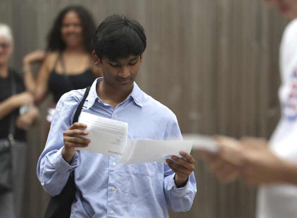 Students at Peter Symonds College, Winchester, England, receive their A-Level results on Thursday Aug. 13, 2020. Thousands of school-leaving children in Britain have been left distraught after finding out Thursday that they were given lower-than-expected grades, with many questioning how the results were calculated after the coronavirus pandemic cancelled exams key for college applications. (Andrew Matthews/PA via AP)