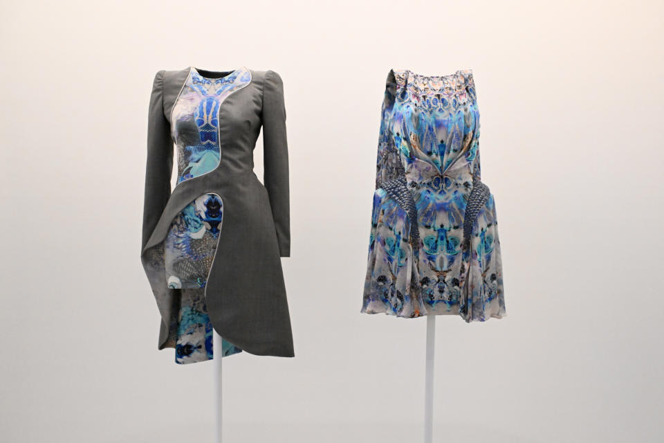 Two patterned dresses on mannequins, one with a jacket and one a skirt ensemble
