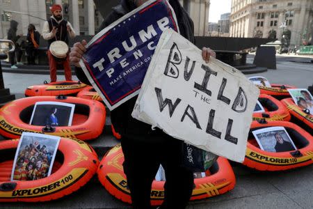 A supporter of U.S. President Donald Trump disrupts a protest against America's refugee ban at Foley Square in New York, U.S., March 29, 2017. Picture taken March 29, 2017. REUTERS/Shannon Stapleton