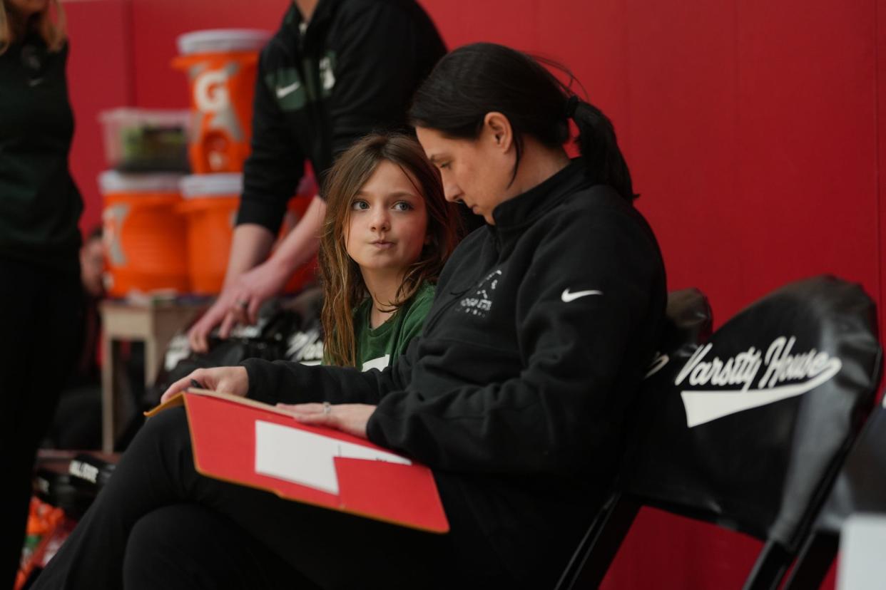 MSU volleyball coach Leah Johnson sits with her oldest daughter Edith