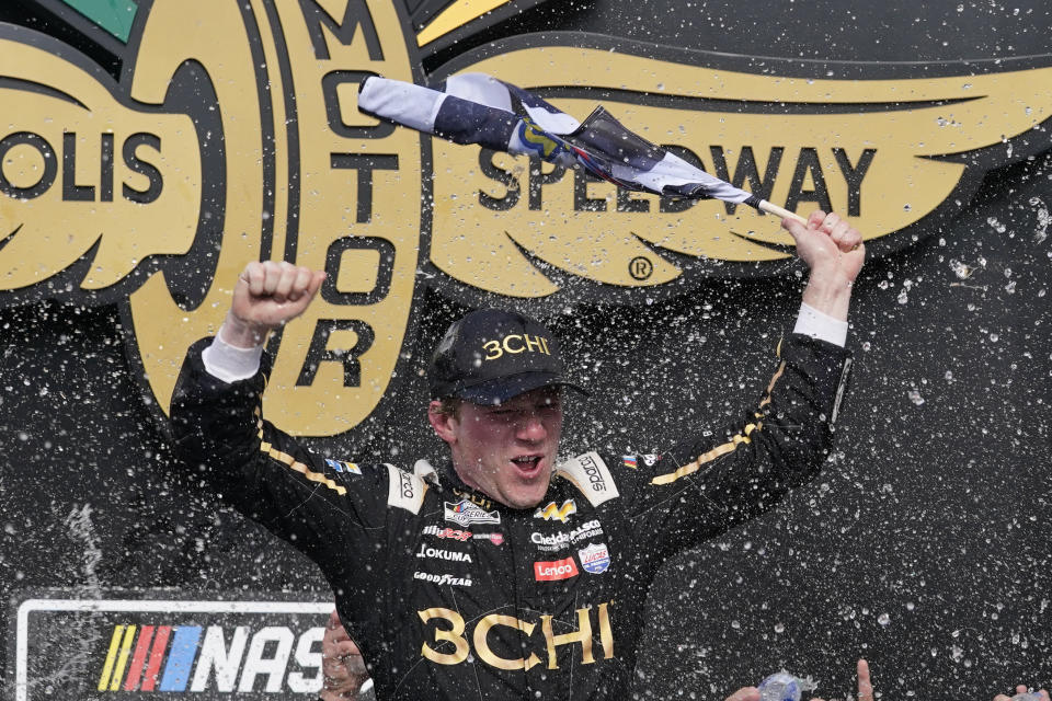 Tyler Reddick celebrates after winning a NASCAR Cup Series auto race at Indianapolis Motor Speedway, Sunday, July 31, 2022, in Indianapolis. (AP Photo/Darron Cummings)