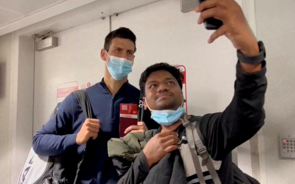 Serbian tennis player Novak Djokovic poses for a selfie after landing at Dubai Airport - LOREN ELLIOTT /REUTERS