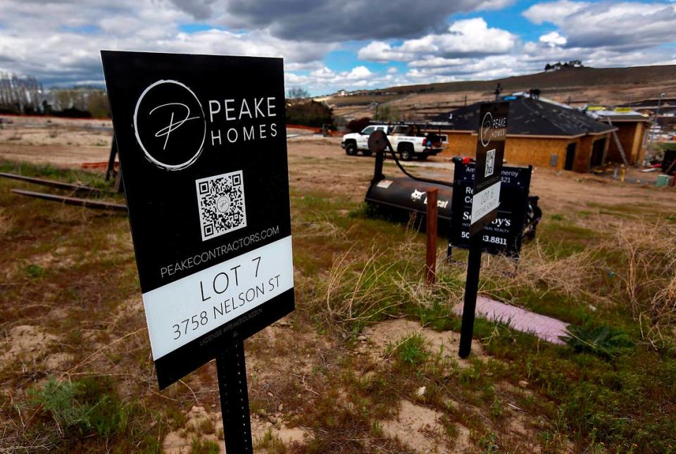 Signs stuck in the ground designate individual lots at the Sage Crest housing development by Peake Homes on South Nelson Street just off Ridgeline Drive in south Kennewick.