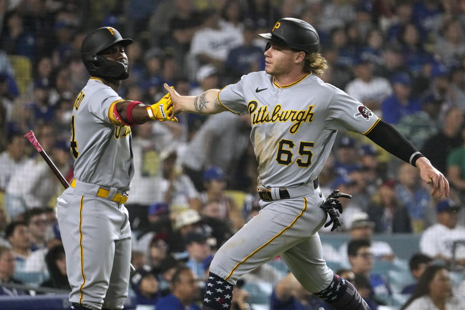 Pittsburgh Pirates' Jack Suwinski, right, is congratulated by Rodolfo Castro after scoring on double by Josh Palacios during the ninth inning of a baseball game against the Los Angeles Dodgers Tuesday, July 4, 2023, in Los Angeles. (AP Photo/Mark J. Terrill)
