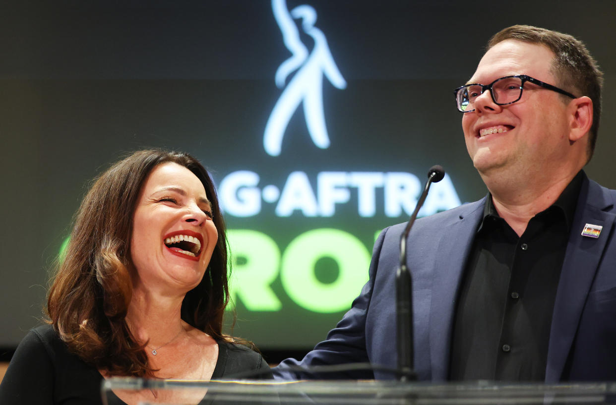 LOS ANGELES, CALIFORNIA - NOVEMBER 10: SAG-AFTRA President Fran Drescher (L) and SAG-AFTRA National Executive Director Duncan Crabtree-Ireland smile at a press conference discussing their strike-ending deal with the Hollywood studios on November 10, 2023 in Los Angeles, California. A tentative labor agreement has been reached between the actors union and the Alliance of Motion Picture and Television Producers (AMPTP) with the strike completed after 118 days, the longest strike in the history of the union. (Photo by Mario Tama/Getty Images)