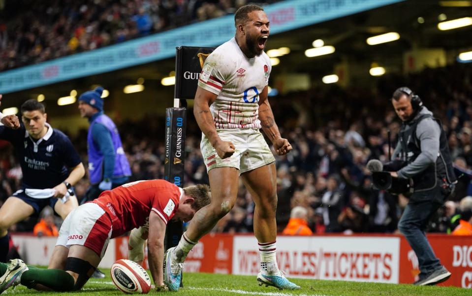 England's Ollie Lawrence celebrates after scoring a try during the Guinness Six Nations match at the Principality Stadium, Cardiff - PA/David Davies