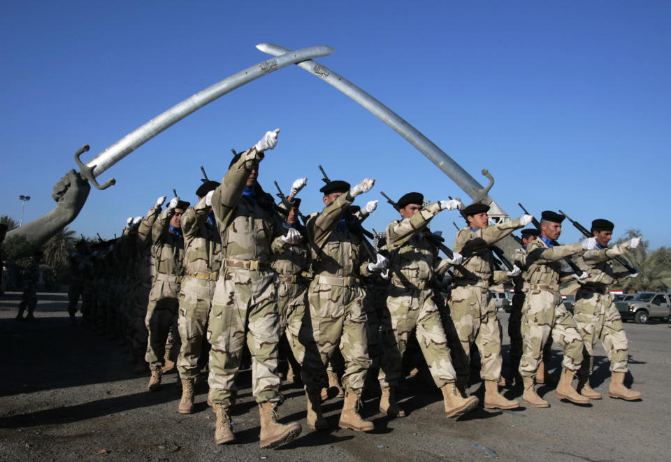 FILE - In this Jan. 3, 2009 file photo, Iraqi soldiers practice ahead of the Army Day parade at the “Victory Arch”, in Baghdad's Green Zone, Iraq. The zone has been a barometer for tension and conflict in Iraq for nearly two decades. The sealed-off area, with its palm trees and monuments, is home to the gigantic U.S. Embassy in Iraq, one of the largest diplomatic missions in the world. It has also been home to successive Iraqi governments and is off limits to most Iraqis. (AP Photo/Karim Kadim, File)