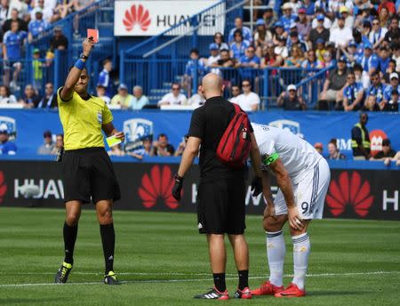 May 21, 2018; Montreal, Quebec, CAN; Los Angeles Galaxy forward Zlatan Ibrahimovic (9) gets a red card from referee Ismail Elfath during the first half of the game against the Montreal Impact at Stade Saputo. Mandatory Credit: Eric Bolte-USA TODAY Sports