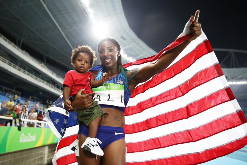 Nia Ali of the United States celebrates with her son Titus after winning the silver medal in the Women’s 100m Hurdles at the Rio 2016 Olympic Games. (Getty)