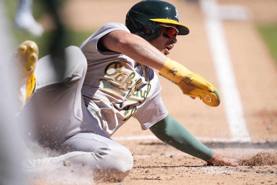 Oakland Athletics' Ryan Noda safely slides at home on a fielder's choice hit into by Abraham Toro during the fourth inning of a baseball game against the Detroit Tigers, Sunday, April 7, 2024, in Detroit. (AP Photo/Carlos Osorio)