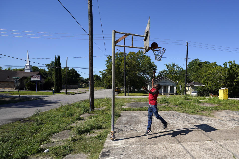 In this Sunday, June 7, 2020, photo, Brent Williams plays basketball in Houston’s Third Ward. George Floyd, who grew up in the Third Ward and had a passion for basketball, died after being restrained by Minneapolis Police officers on Memorial Day. (AP Photo/David J. Phillip)