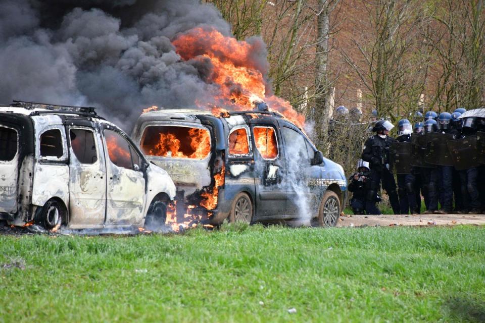 A gendarmerie vehicle burns during a demonstration in Sainte-Soline, France (AFP via Getty Images)