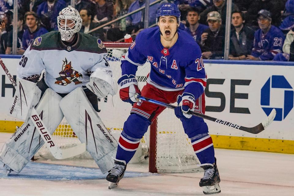 New York Rangers' Chris Kreider, right, calls to a teammate as he stands next to the Arizona Coyotes goal during an NHL hockey game Monday, Oct. 16, 2023, in New York.