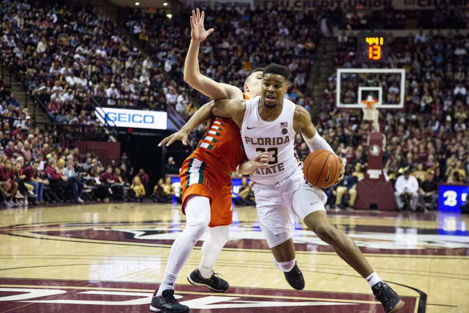 Florida State guard M.J. Walker (23) drives past Miami guard Dejan Vasiljevic (1) in the second half of an NCAA college basketball game in Tallahassee, Fla., Saturday, Feb. 8, 2020. Florida State defeated Miami 99-81. (AP Photo/Mark Wallheiser)