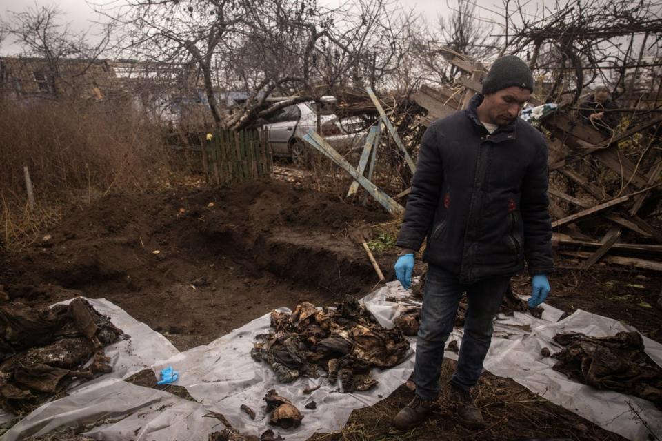 Ukrainian authorities exhume a burial site containing the bodies of six civilians that were executed by Russian forces (Getty Images)