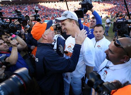 Jan 19, 2014; Denver, CO, USA; Denver Broncos head coach John Fox and quarterback Peyton Manning (18) celebrate after the 2013 AFC championship playoff football game against the New England Patriots at Sports Authority Field at Mile High. Mandatory Credit: Matthew Emmons-USA TODAY Sports