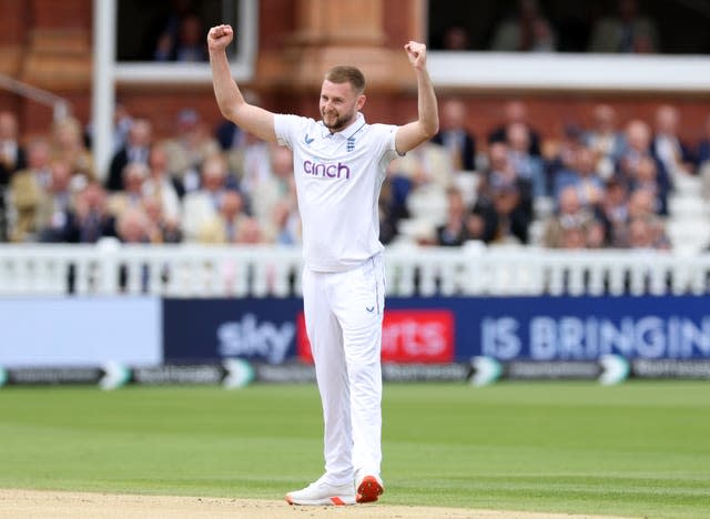 England's Gus Atkinson holds his arms aloft in celebration at Lord's