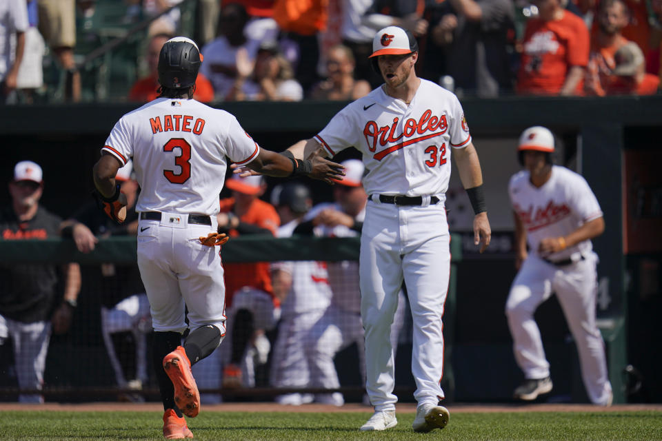 Baltimore Orioles' Jorge Mateo (3) and Ryan O'Hearn (32) react after scoring on a single by teammate Ryan McKenna during the second inning of a baseball game against the Cleveland Guardians, Wednesday, May 31, 2023, in Baltimore. (AP Photo/Julio Cortez)