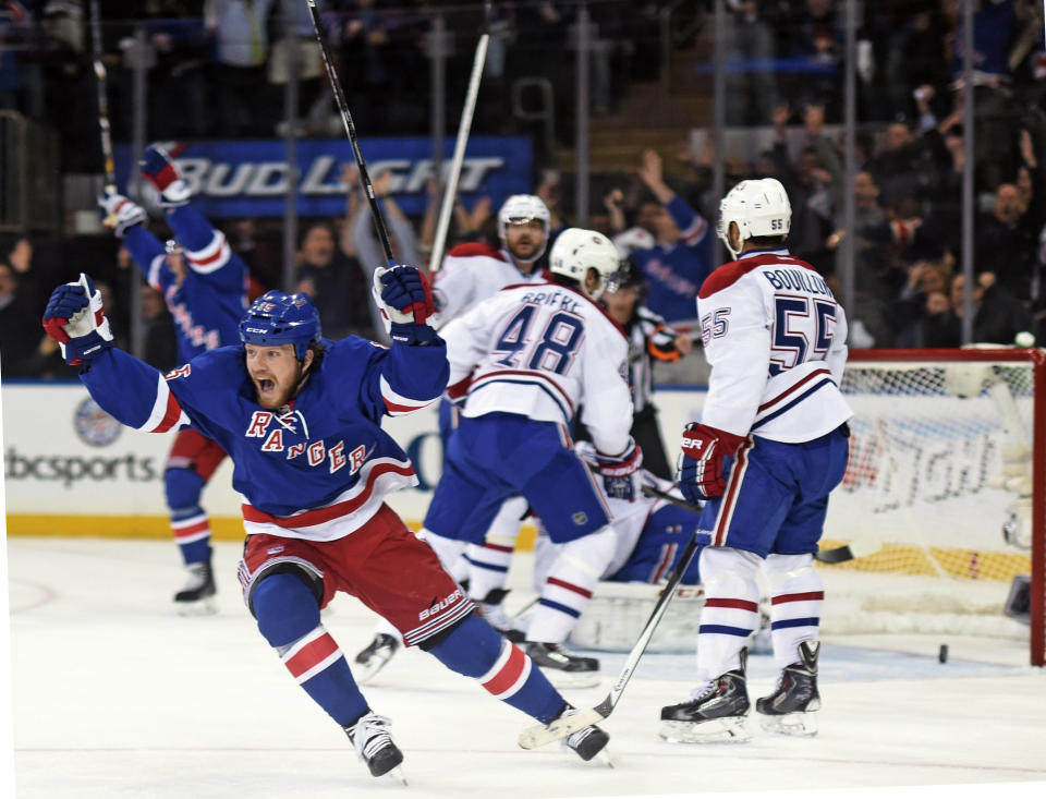 In this Thursday, May 29, 2014 photo, New York Rangers right wing Derek Dorsett (15) reacts after center Dominic Moore (28) scored against the Montreal Canadiens during the second period in Game 6 of the NHL hockey Stanley Cup playoffs Eastern Conference finals in New York. The Rangers won 1-0 to advance to the Stanley Cup finals. (AP Photo/Dick Druckman)