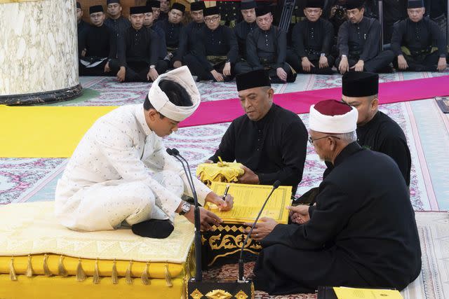 <p>Brunei's Information Department via AP</p> Prince Abdul Mateen signs documents after his solemnization at Sultan Omar Ali Saifuddien Mosque in Bandar Seri Begawan, Brunei on Jan. 11.