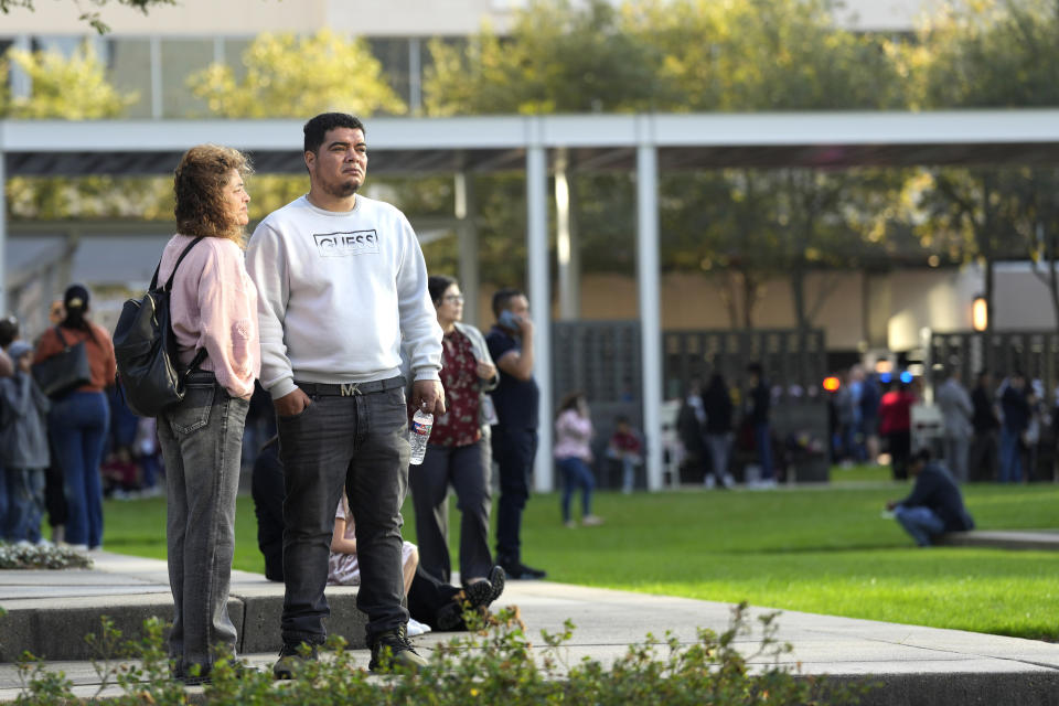 People wait outside Lakewood Church, Sunday, Feb. 11, 2024, in Houston, after a reported shooting during a Spanish church service. (Karen Warren/Houston Chronicle via AP)