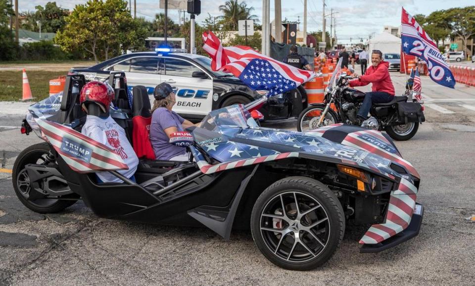 Motorists await the arrival of U.S. President Donald Trump and his motorcade along Southern Boulevard on his way to Mar-a Lago in Palm Beach on Wednesday, Jan. 20, 2021.