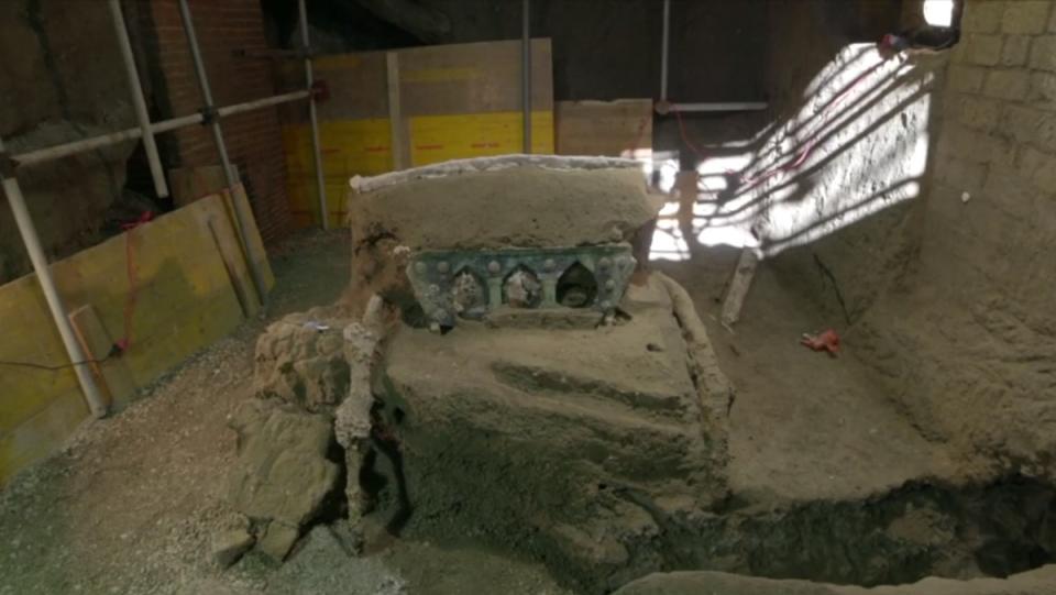 a photo of an ancient Roman chariot fully preserved at an excavation site