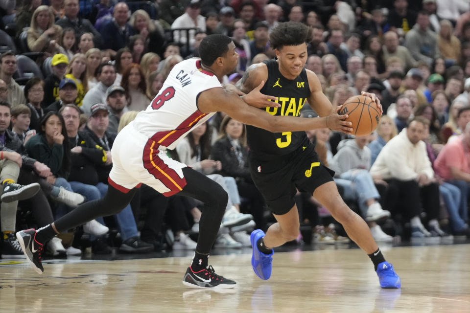 Utah Jazz guard Keyonte George (3) drives as Miami Heat forward Jamal Cain (8) defends during the second half of an NBA basketball game Saturday, Dec. 30, 2023, in Salt Lake City. (AP Photo/Rick Bowmer)