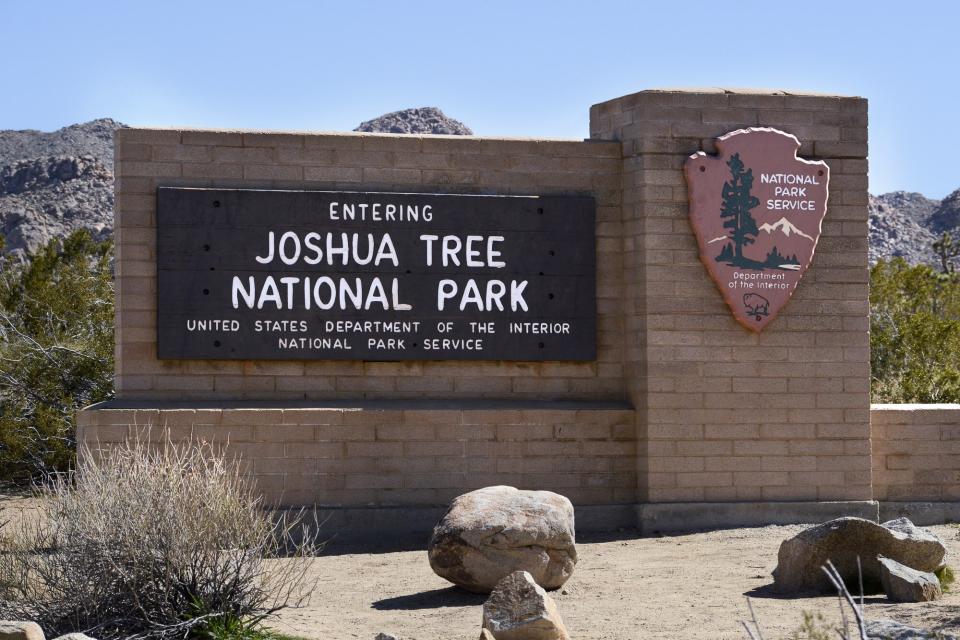 A National Park Service sign welcomes visitors to Joshua Tree National Park in California.