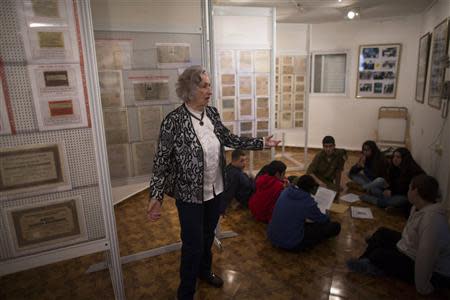 Jewish Holocaust survivor Irena Wodzislawski gestures near a group of Israeli youths visiting a museum inside her home in the West Bank Jewish settlement of Ariel, commemorating the six million victims of the Nazi genocide, January 23, 2014. REUTERS/Ronen Zvulun