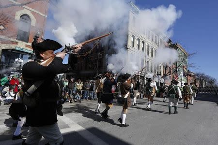 A historic reenactment group fires blanks as they march down Broadway during the annual South Boston St. Patrick's Day parade in Boston, Massachusetts March 16, 2014. REUTERS/Dominick Reuter