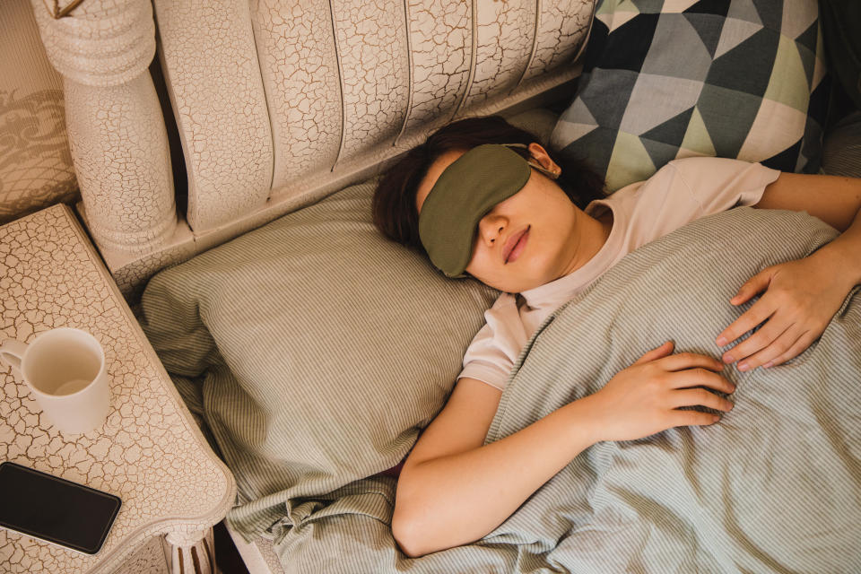 a person sleeping with a sleep mask