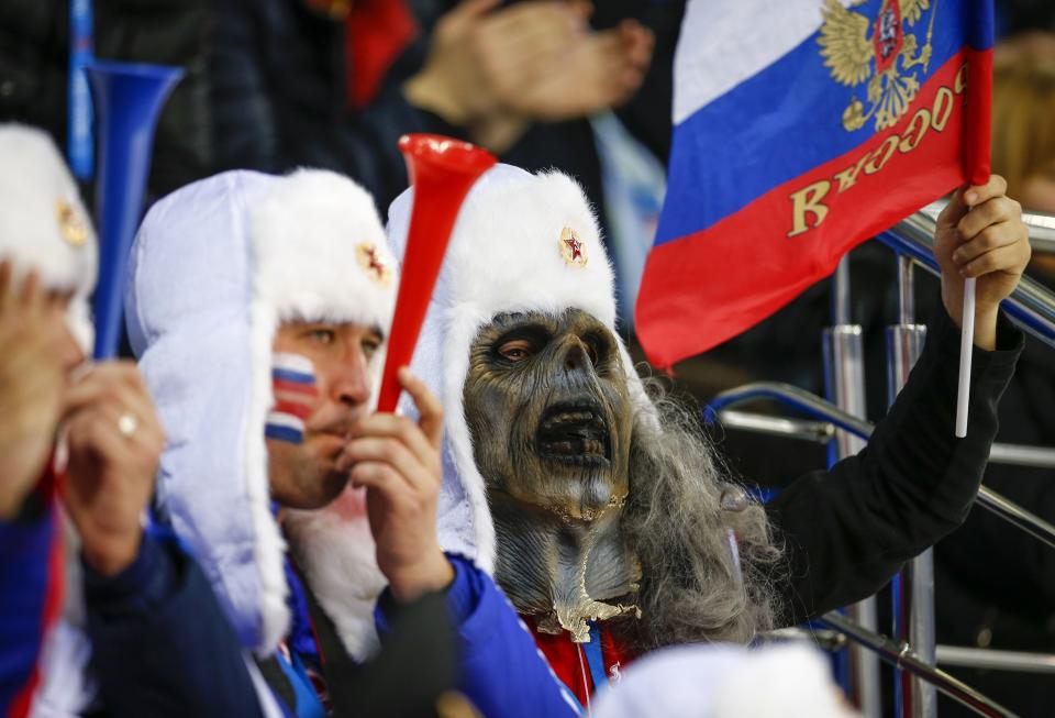 A Russian fan wearing a mask watches the women's preliminary round ice hockey game during the 2014 Sochi Winter Olympics