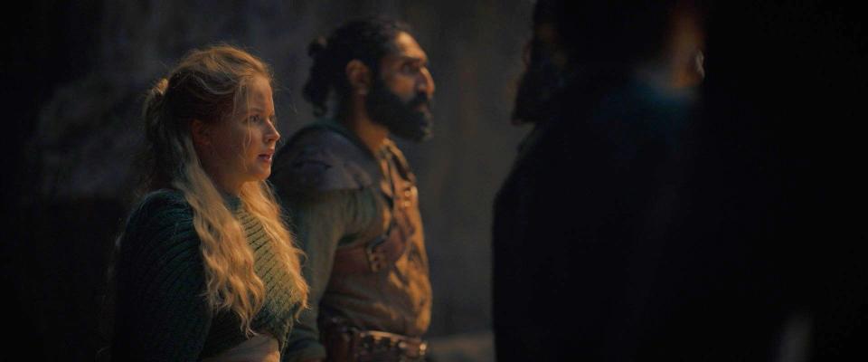 Ellie Bamber and Amar Chadha-Patel wear medieval costumes in a scene from the show