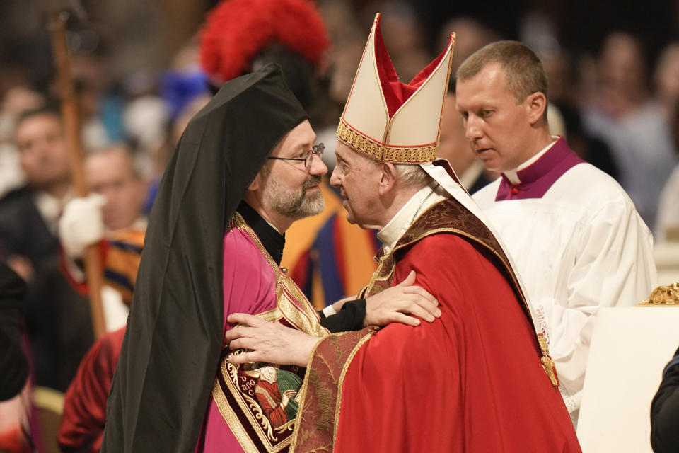 Job of Telmessos, Ihor Wladimir Getcha, the Eastern Orthodox Archbishop of the Ecumenical Patriarchate, left, hugs Pope Francis at the end of a Mass during the Solemnity of Saints Peter and Paul, in St. Peter's Basilica at the Vatican, Wednesday, June 29, 2022. (AP Photo/Alessandra Tarantino)