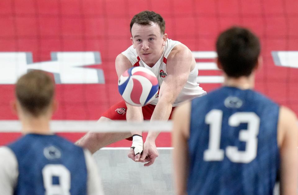 Ohio State libero Thomas Poole makes a dig against Penn State.