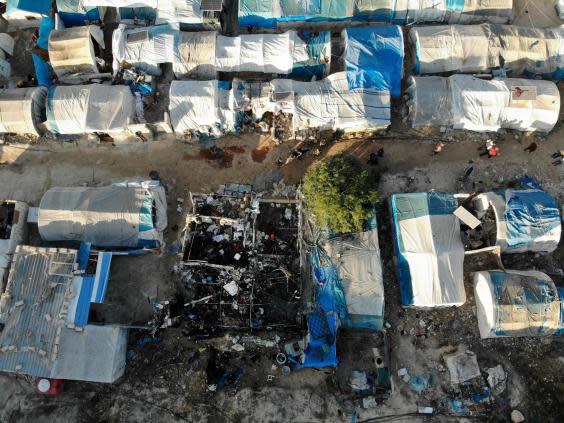 An aerial view taken shows the charred remains of a tent following Syrian regime bombardment on a makeshift camp in the village of Qah (AFP via Getty Images)